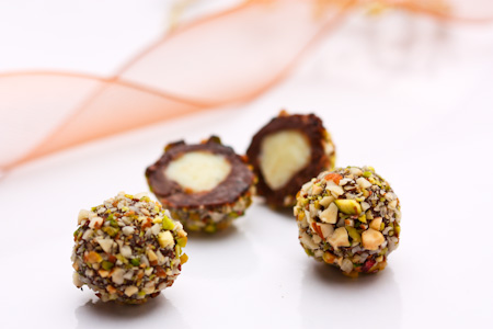 Dark and white Christmas truffles with crushed nuts